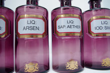 Load image into Gallery viewer, Set of Four Early 20th Century Apothecary Bottles (Purple Glass)
