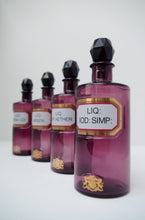 Load image into Gallery viewer, Set of Four Early 20th Century Apothecary Bottles (Purple Glass)
